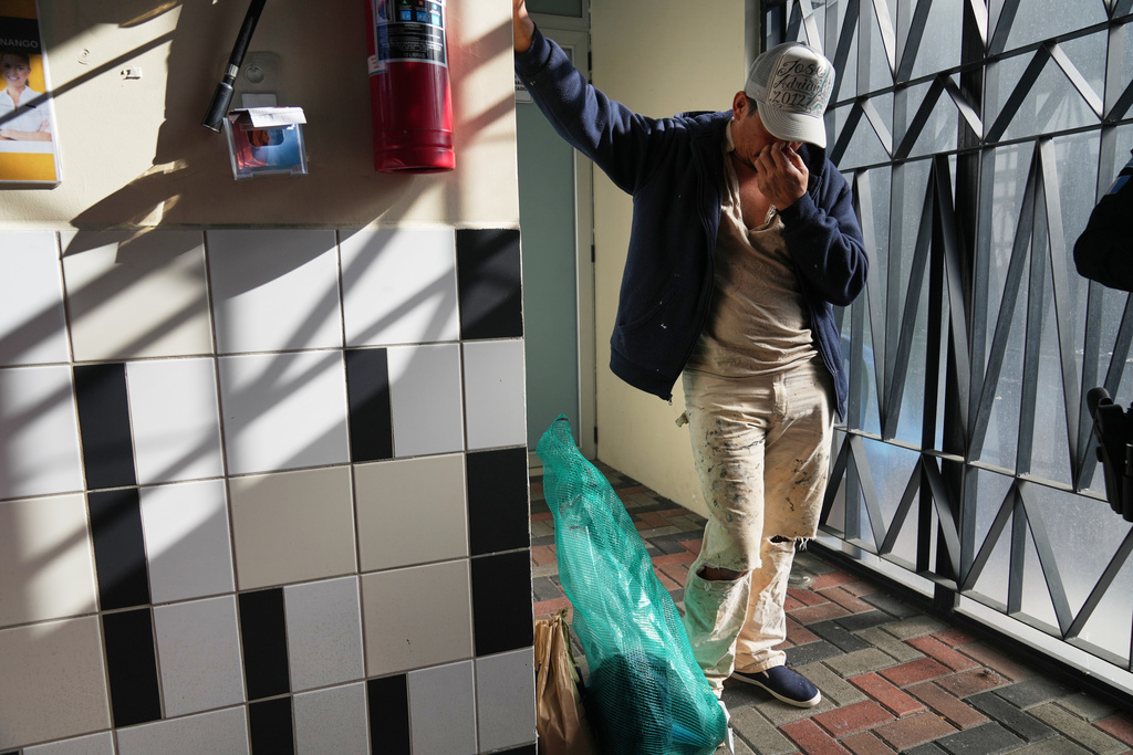 FILE - A Guatemalan deported from the U.S. waits to leave a processing center after returning with other migrants on a repatriation flight to La Aurora airport in Guatemala City, Dec. 30, 2025. The man, who did not want to give his name, said he was detained while on his way to work at a construction site in Georgia. (AP Photo/Moises Castillo, File)