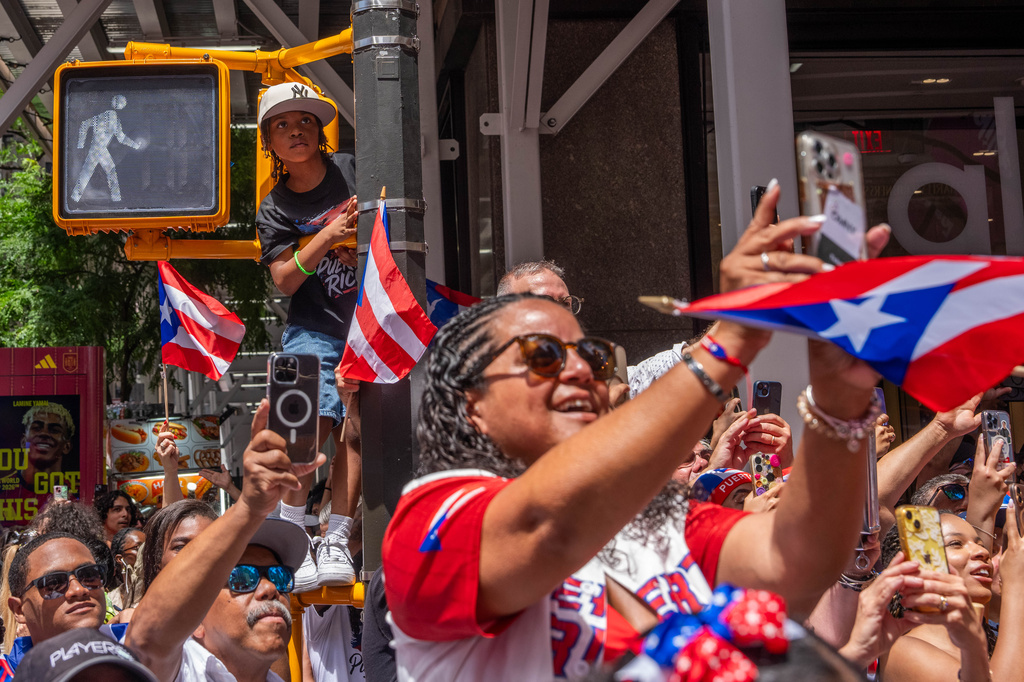 Crowds watch the National Puerto Rican Day Parade, Sunday, June 14, 2026 in New York. (AP Photo/Adam Gray)