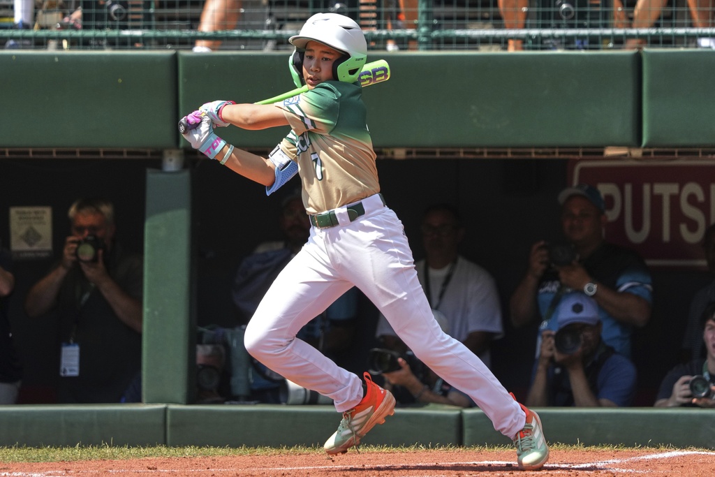 Taiwan's Muhammad Zaman (7) drives in a run with a single off Aruba's Jayderick Wederfoor (18) during the third inning of the International Championship baseball game at the Little League World Series tournament in South Williamsport, Pa., Saturday, Aug. 23, 2025. (AP Photo/Gene J. Puskar)
