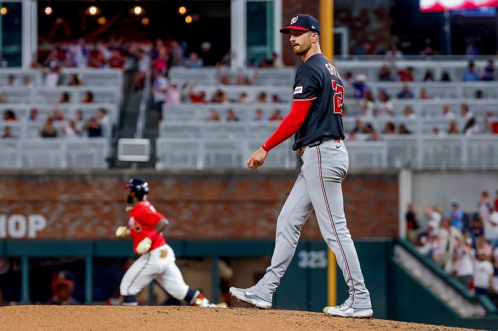 Washington Nationals pitcher Foster Griffin, right, reacts on the mound after giving up a three-run home run to Atlanta Braves' Michael Harris II, left, during the sixth inning of a baseball game, Friday, July 31, 2026, in Atlanta. (AP Photo/Erik S. Lesser)