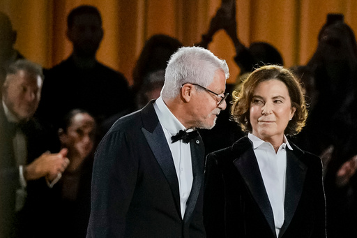 Leo Dell'Orco, left, and Silvana Armani acknowledge the applause at the end of the Giorgio Armani Spring/Summer 2026 collection show in Milan, Italy, Sunday, Sept. 28, 2025. (AP Photo/Luca Bruno) Leo Dell'Orco, left, and Silvana Armani acknowledge the applause at the end of the Giorgio Armani Spring/Summer 2026 collection show in Milan, Italy, Sunday, Sept. 28, 2025. (AP Photo/Luca Bruno)