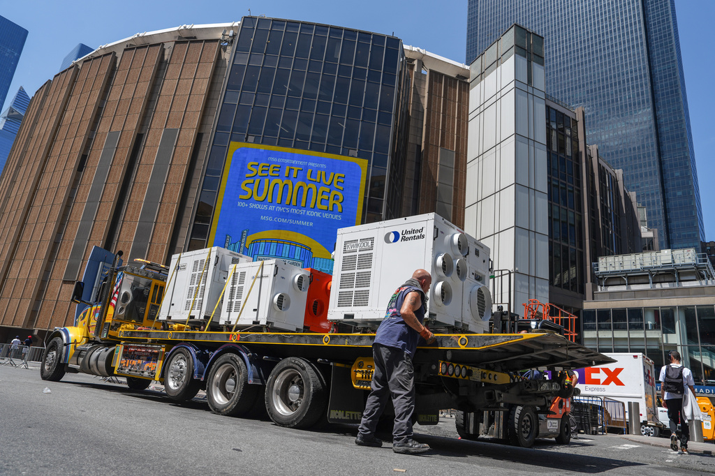 A worker unloads portable air-conditioning units outside of Madison Square Garden ahead of a reported wedding between singer Taylor Swift and National Football League player Travis Kelce on Thursday, July 2, 2026, in New York. (AP Photo/Ryan Murphy)