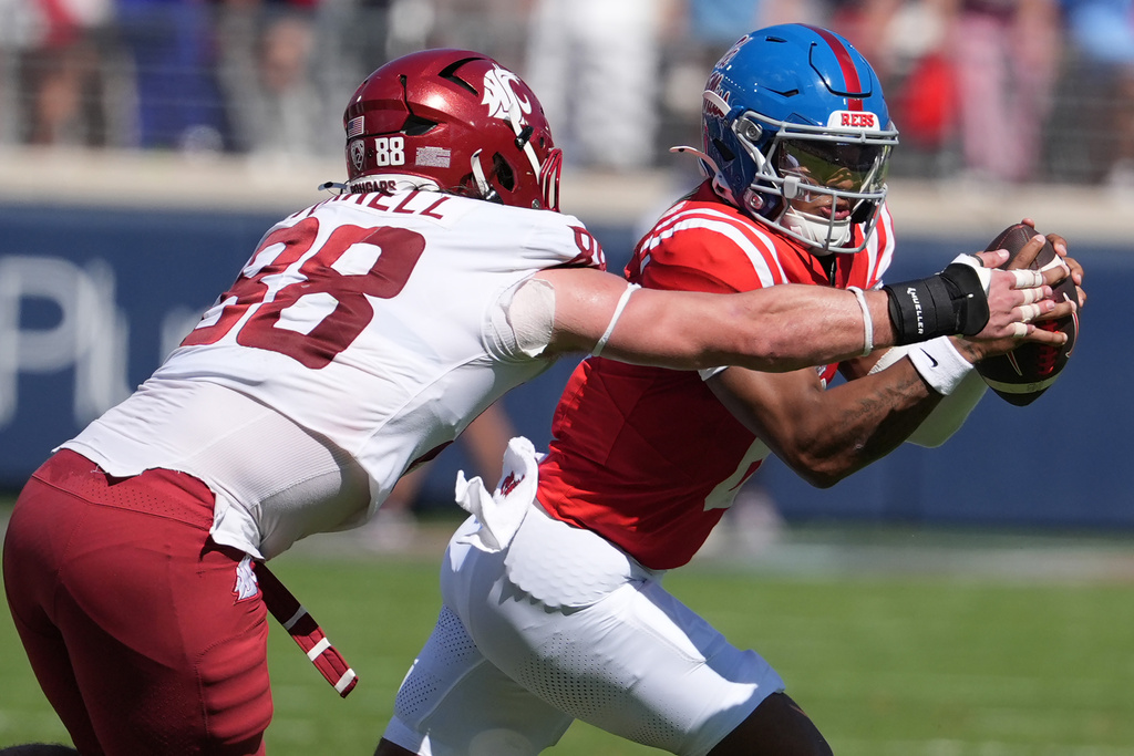 Mississippi quarterback Trinidad Chambliss (6) is sacked by Washington State defensive end Isaac Terrell (88) during the first half of an NCAA college football game, Saturday, Oct. 11, 2025, in Oxford, Miss. (AP Photo/Rogelio V. Solis)