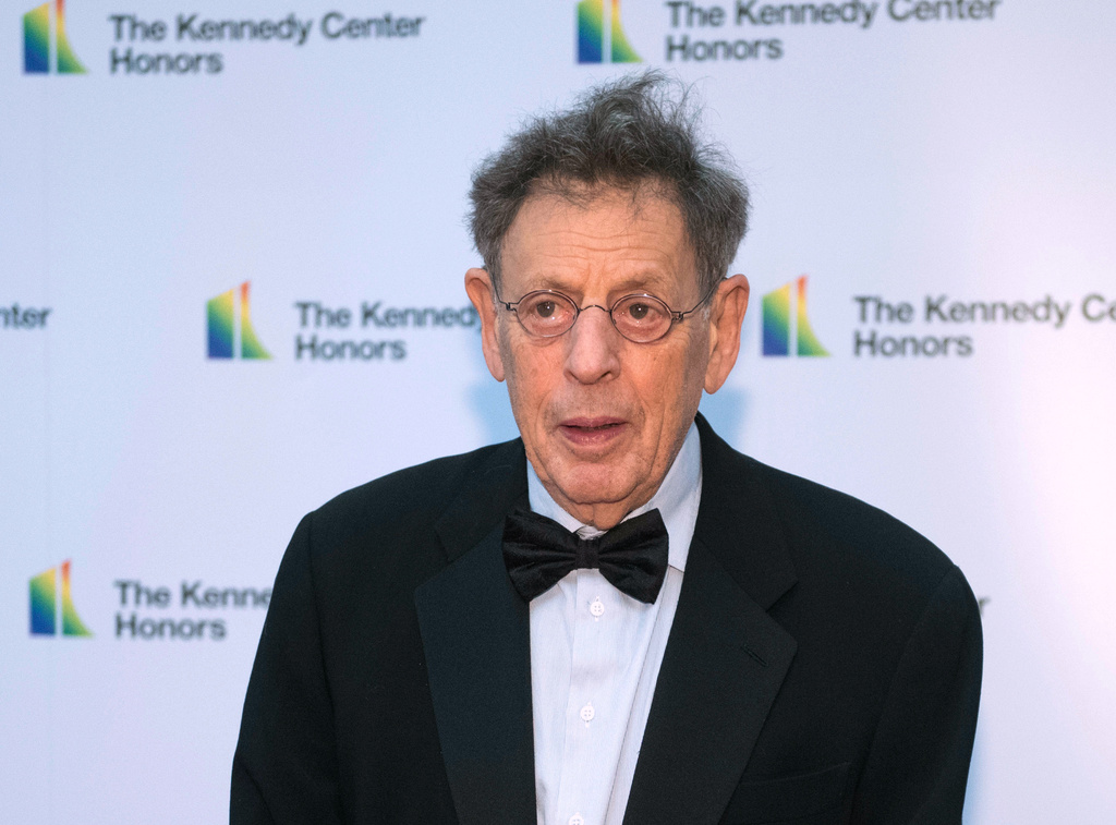 FILE - 2018 Kennedy Center Honoree composer Philip Glass arrives at the State Department for the Kennedy Center Honors State Department Dinner, Dec. 1, 2018, in Washington. (AP Photo/Kevin Wolf, File)