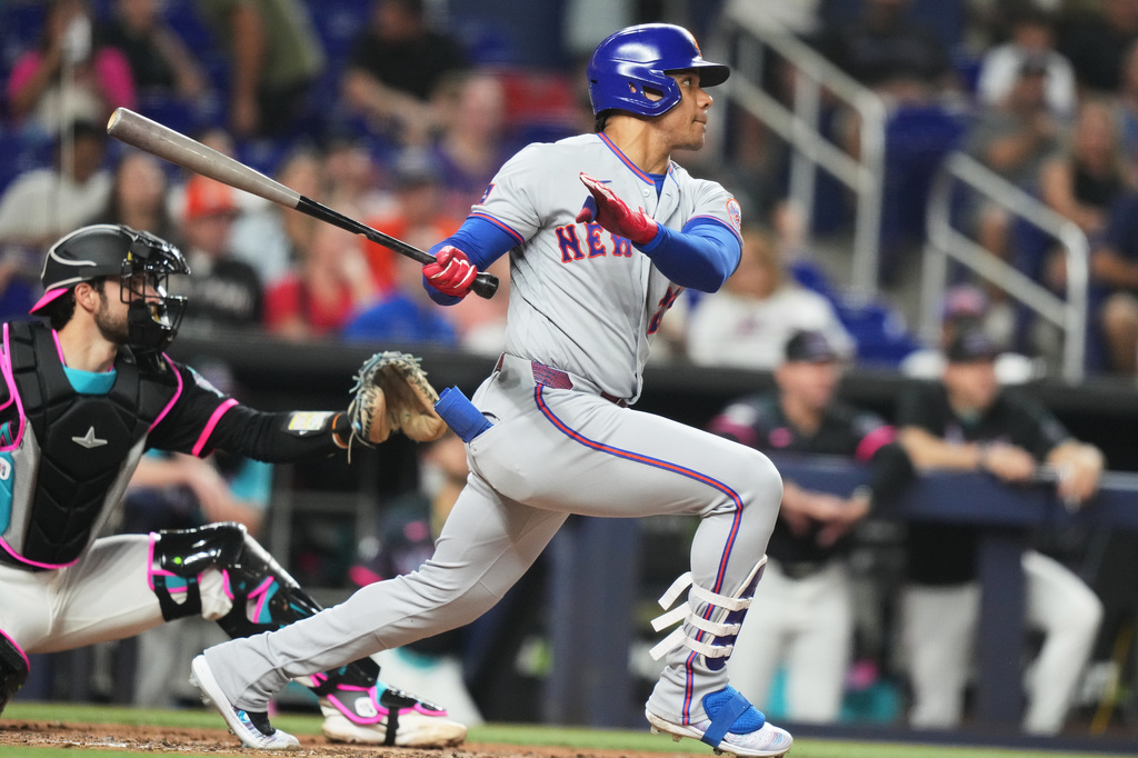 New York Mets' Juan Soto hits a single during the fourth inning of a baseball game against the Miami Marlins, Friday, May 22, 2026, in Miami. (AP Photo/Lynne Sladky)