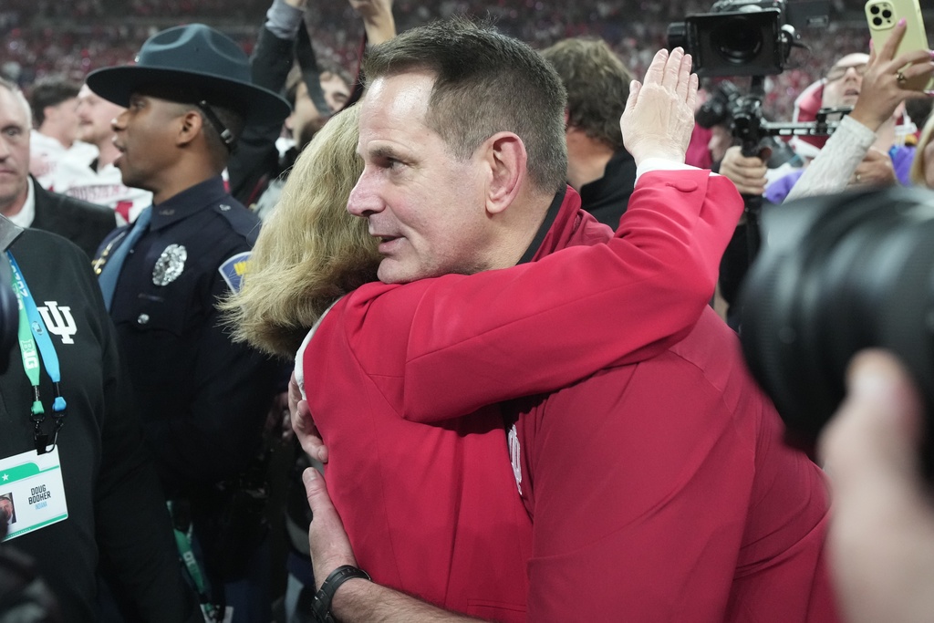 Indiana head coach Curt Cignetti celebrates with Indiana University President Pamela Whitten after the Big Ten championship NCAA college football game against Ohio State in Indianapolis, Saturday, Dec. 6, 2025. (AP Photo/AJ Mast)