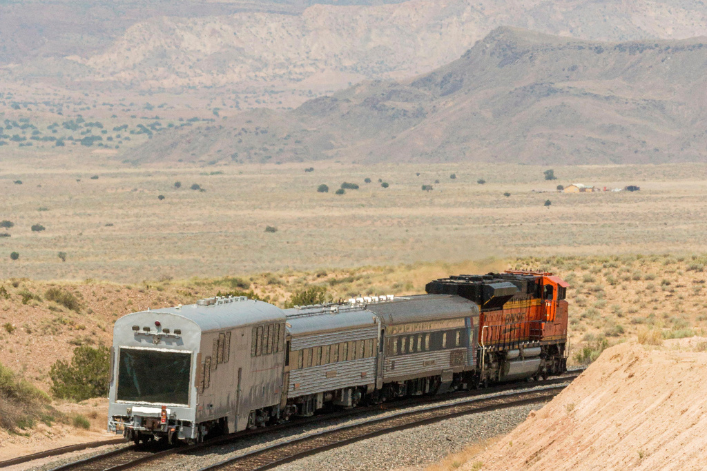 A BNSF locomotive pulls an automated track inspection railcar down the tracks in Valencia County, New Mexico, July 31, 2018. (BNSF Railway via AP)