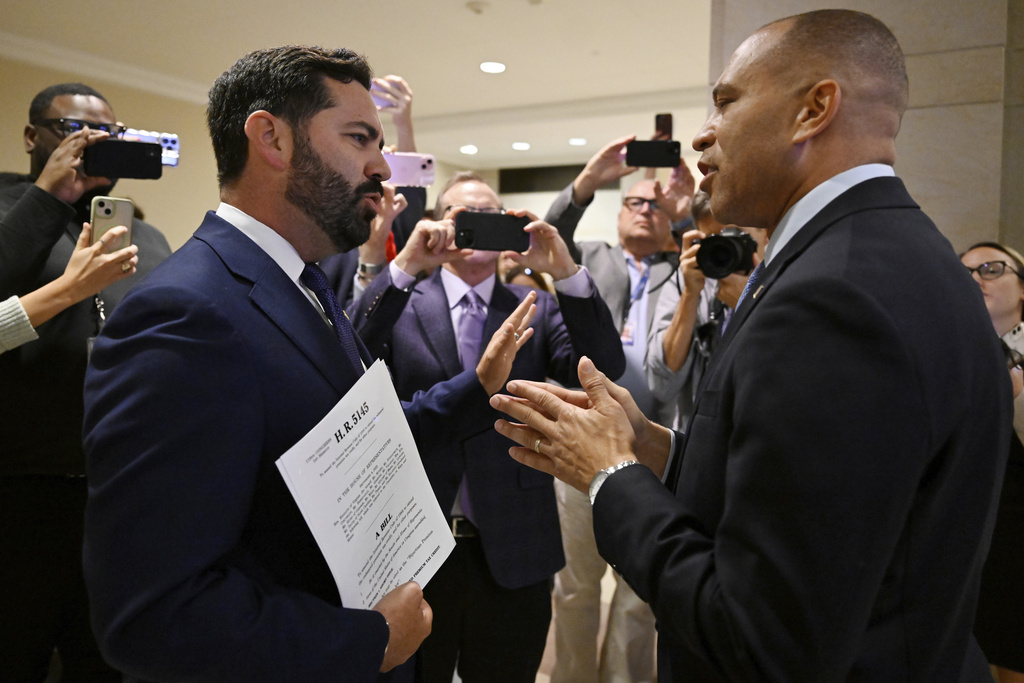 Rep. Michael Lawler, R-N.Y., left, confronts House Minority Leader Hakeem Jeffries, D-N.Y., in a heated discussion to endorse House bill H.R.5145 that would extend the American Rescue Plan Act of 2021 (ARPA) and the Inflation Reduction Act of 2022 at the U.S. Capitol on Wednesday, Oct. 8, 2025, in Washington. (AP Photo/John McDonnell)