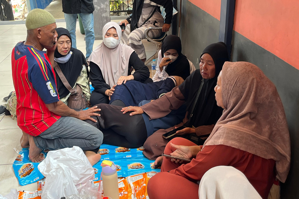 People wait for the news on their relatives who were among the passengers of the ferry that overturned in bad weather in the Java Sea on Sunday, in Banjarmasin, South Kalimantan, Indonesia, Monday, Sept. 14, 2026. (AP Photo/Iman Satria)