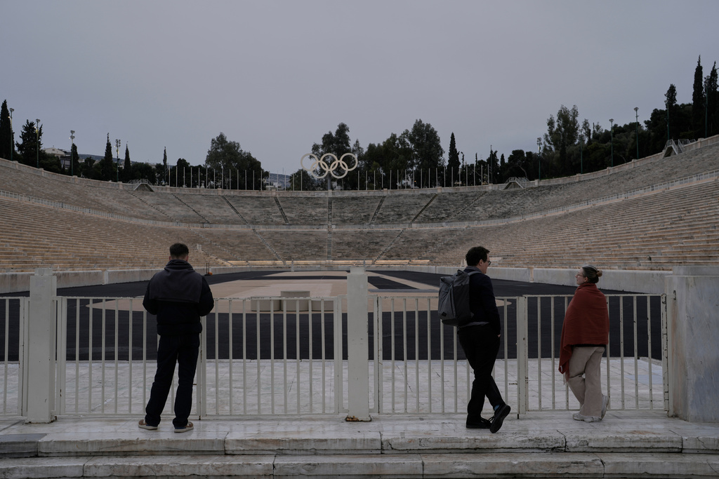 People stand outside the Panathenaic Stadium with the Olympic rings, in Athens on Jan. 27, 2026, the site of the first modern Olympic Games in 1896. (AP Photo/Petros Giannakouris)