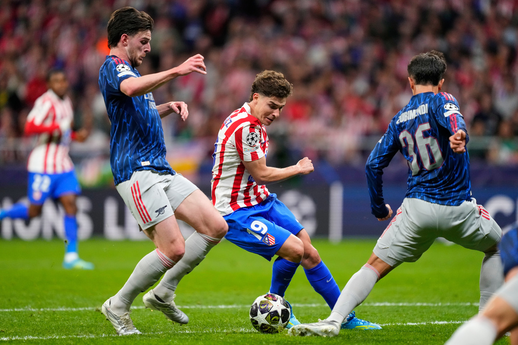 Atletico Madrid's Julian Alvarez, center, is challenged by Arsenal's Declan Rice during a Champions League semifinal, first leg, soccer match between Atletico Madrid and Arsenal in Madrid, Spain, Wednesday, April 29, 2026. (AP Photo/Jose Breton)