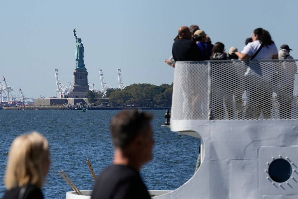 People board a boat headed to the Statue of Liberty in New York, Wednesday, Oct. 1, 2025. (AP Photo/Seth Wenig)