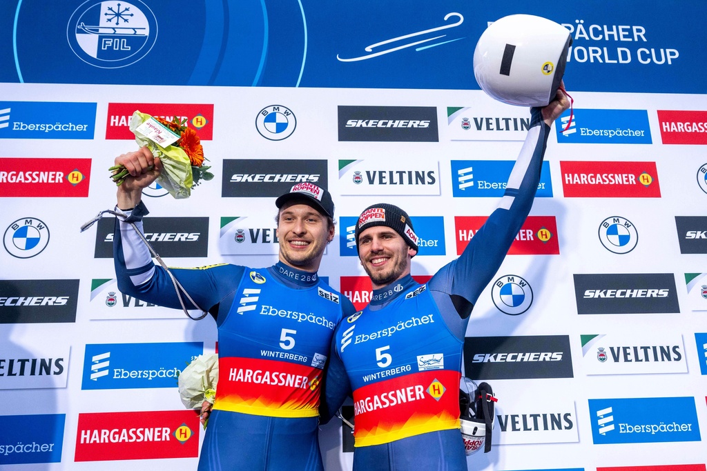 Austria's Juri Thomas Gatt, left, and Riccardo Martin Schoepf, right, pose for a picture after the Luge World Championships in Winterberg, Germany, Saturday, Dec. 6, 2025. (David Inderlied/dpa via AP)
