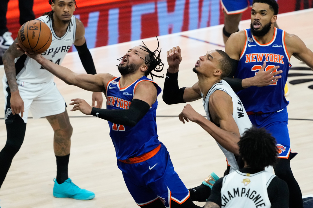 New York Knicks guard Jalen Brunson, left, drives past San Antonio Spurs forward Victor Wembanyama during the second half of Game 5 of the NBA Finals basketball series, Saturday, June 13, 2026, in San Antonio. (AP Photo/Ross D. Franklin)