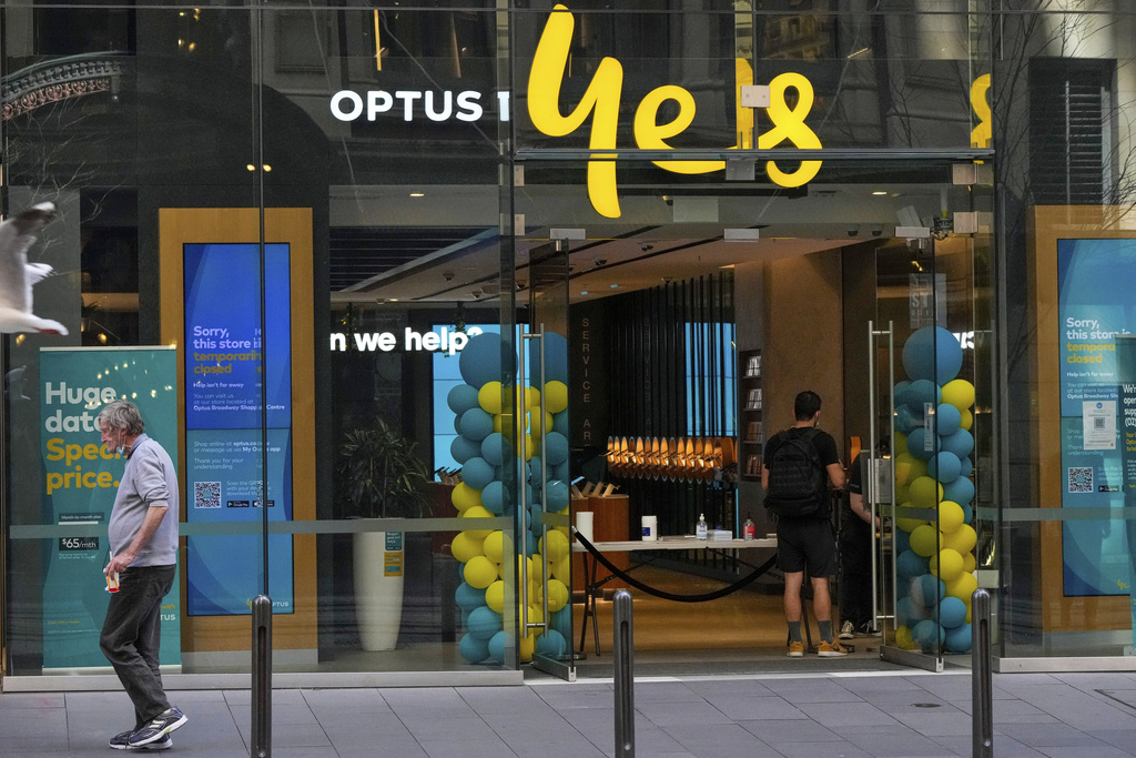 FILE - A customer waits for service at a Optus store in Sydney, Australia, Thursday, Oct. 7, 2021. (AP Photo/Mark Baker, File)