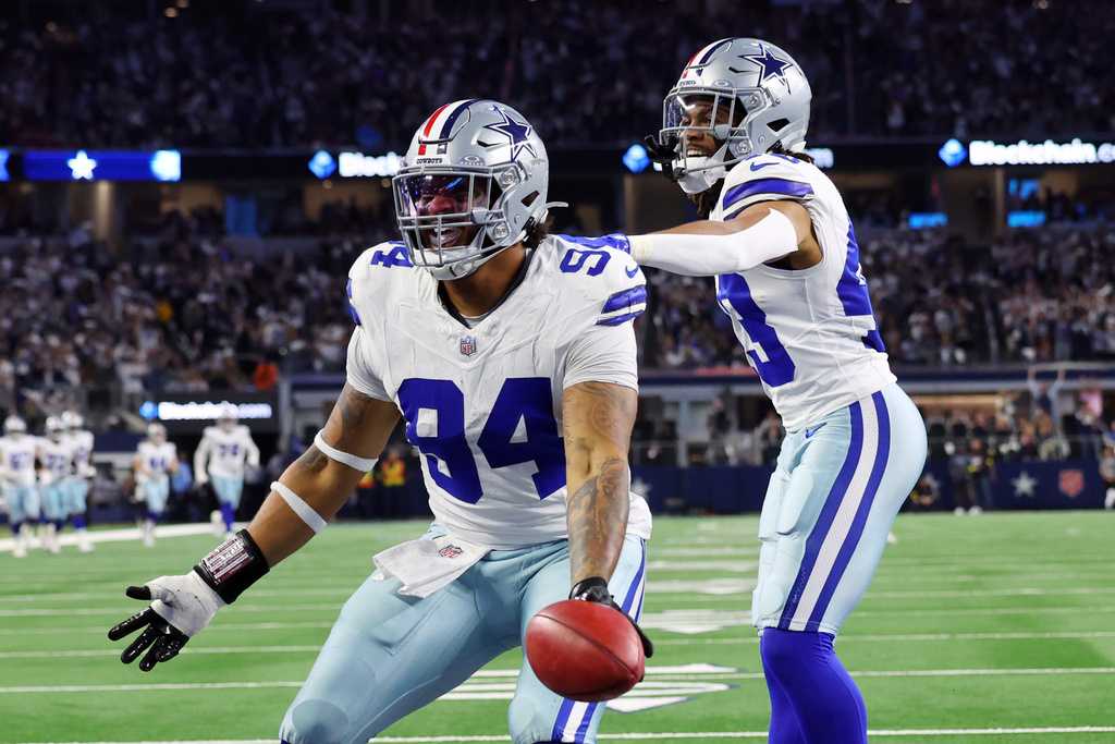 Dallas Cowboys defensive end Marshawn Kneeland (94) celebrates with Malik Davis (43), after he recovered a blocked punt for a touchdown in the first half of an NFL football game against the Arizona Cardinals first half of an NFL football game Monday, Nov. 3, 2025, in Arlington, Texas. (AP Photo/Richard Rodriguez)