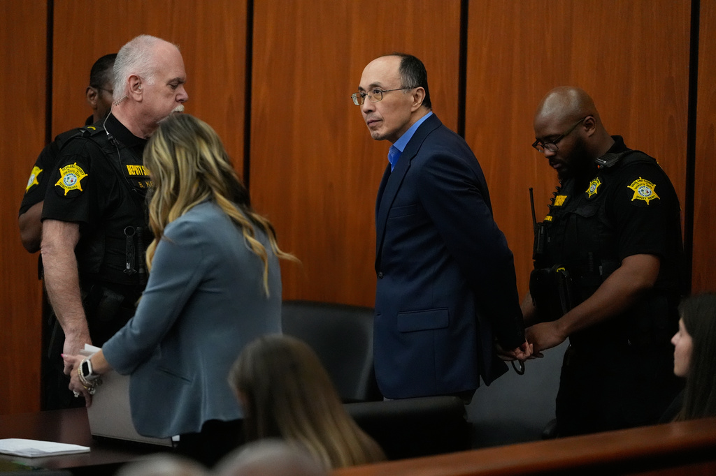 Chikei Rick Chow, a convenience store owner accused in the 2023 fatal shooting of a Black 14-year-old, is escorted out of the courtroom during closing arguments in his murder trial, Monday, June 1, 2026, in Columbia, S.C. (AP Photo/Erik Verduzco)