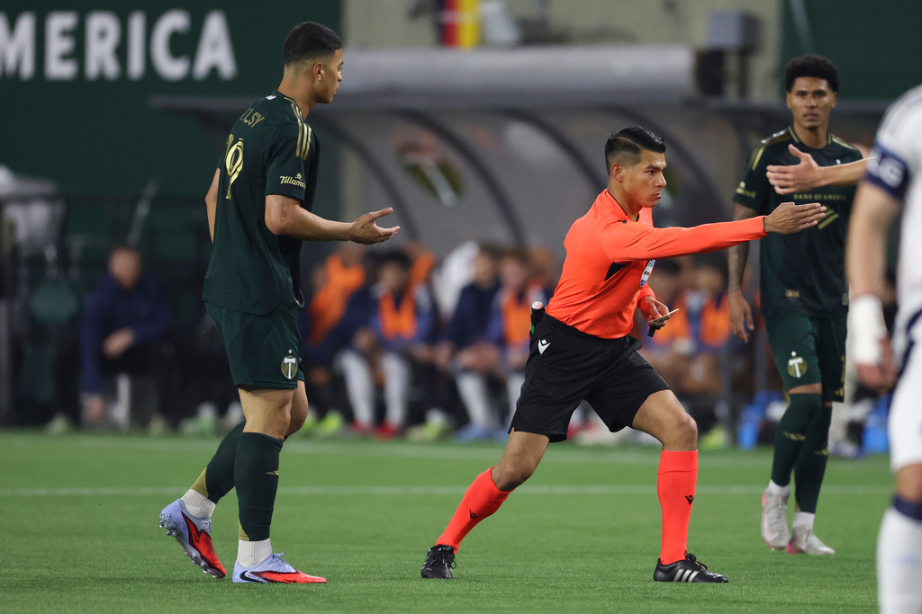 Portland Timbers' Kevin Kelsy (19) is given a yellow card by an official during the first half of an MLS soccer match against the Vancouver Whitecaps, Saturday, March 7, 2026, in Portland, Ore. (AP Photo/Amanda Loman)