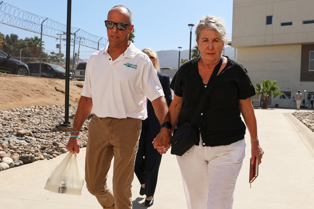 Debra and Martin Robinson, the parents of Australian brothers Callum and Jake Robinson, arrive to court for the trial of the men accused of murdering them, in Ensenada, Mexico, Thursday, Oct. 8, 2026. (AP Photo/Karen Castaneda)