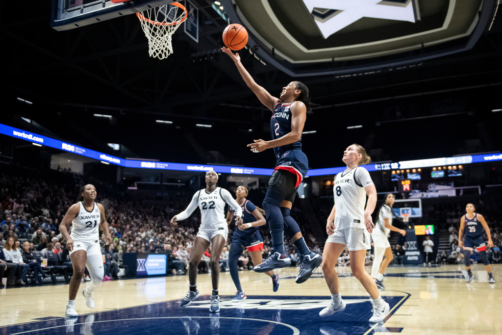 UConn guard KK Arnold (2) shoots during the second quarter of an NCAA college basketball game against Xavier, Sunday, Nov. 30, 2025, in Cincinnati. (AP Photo/Tanner Pearson)