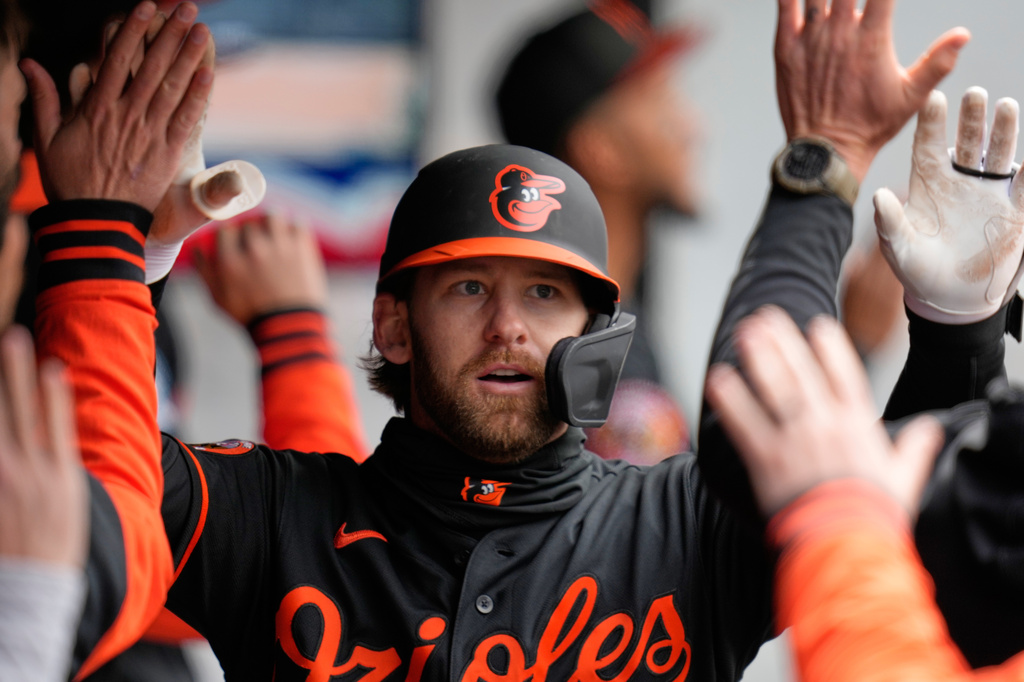Baltimore Orioles' Taylor Ward is congratulated in the dugout after hitting a home run in the fifth inning of a baseball game against the Cleveland Guardians in Cleveland, Sunday, April 19, 2026. (AP Photo/Sue Ogrocki)