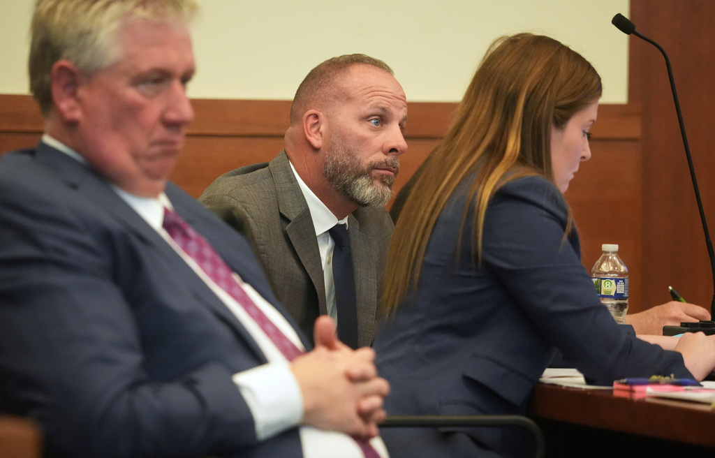 FILE - Jason Meade, center, sits with his attorneys Mark Collins, left, and Kaitlyn Stephens, right, during opening statements in the retrial of the former Ohio sheriff's deputy charged with murder and reckless homicide in the 2020 killing of Casey Goodson Jr., inside Franklin County Common Pleas Court in Columbus, Ohio, April 23, 2026. (Doral Chenoweth/Pool photo via AP, File)