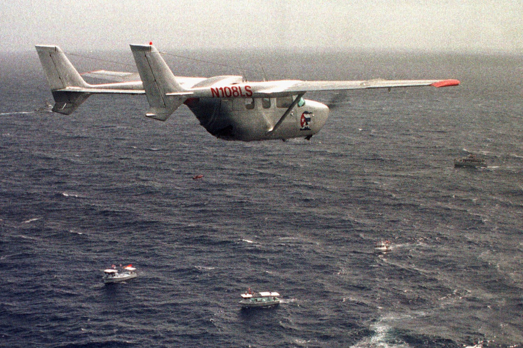 FILE - A Brothers to the Rescue plane flies over The Democracy Movement flotilla at the twelve-mile limit north of Havana, Cuba, July 10, 1999. (AP Photo/Alan Diaz, File)