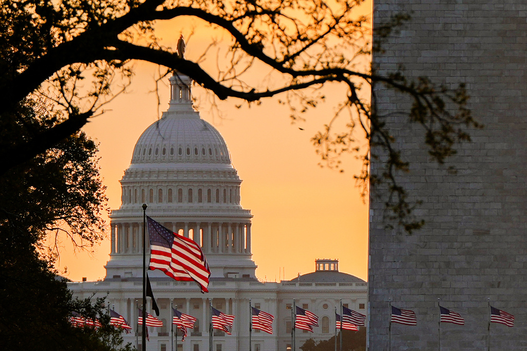 American flags fly in front of the U.S. Capitol at sunrise, Wednesday, Oct. 1, 2025, in Washington. (AP Photo/Julia Demaree Nikhinson)