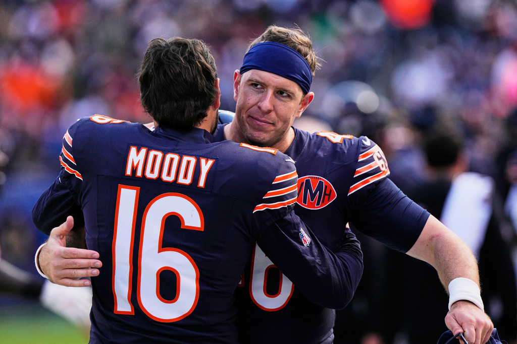 Chicago Bears kicker Jake Moody (16) and long snapper Scott Daly greet each other after an NFL football game against the New Orleans Saints, Sunday, Oct. 19, 2025, in Chicago. (AP Photo/Nam Huh)