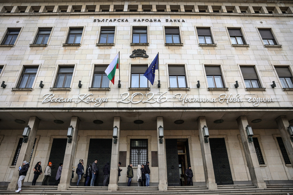 People wait in line to buy packages of new Euro coins with Bulgarian symbols at the doorstep of Bulgarian National Bank, in Sofia, Saturday Dec. 27, 2025. (AP Photo/Valentina Petrova)