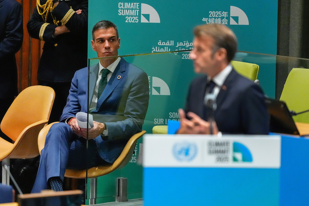 Spanish Prime Minister Pedro Sanchez, left, listens as French President Emmanuel Macron speaks during a climate summit, Wednesday, Sept. 24, 2025, at U.N. headquarters. (AP Photo/Yuki Iwamura)