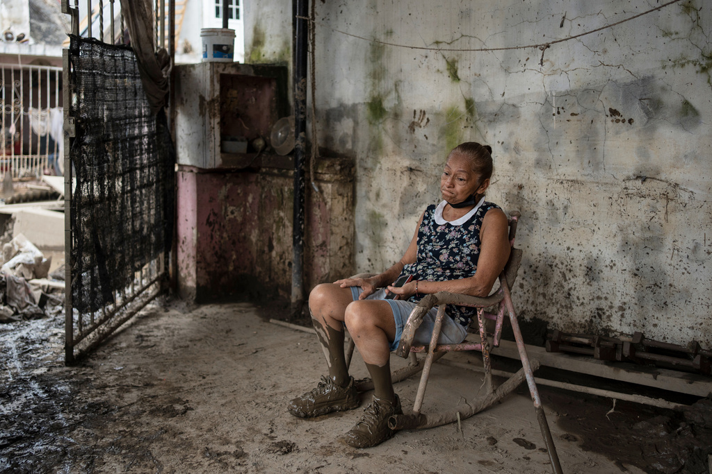 Angela Perez sits on a chair in her house in Poza Rica, Veracruz state, Mexico, Wednesday, Oct. 15, 2025, after deadly floods and torrential rain. (AP Photo/Felix Marquez)