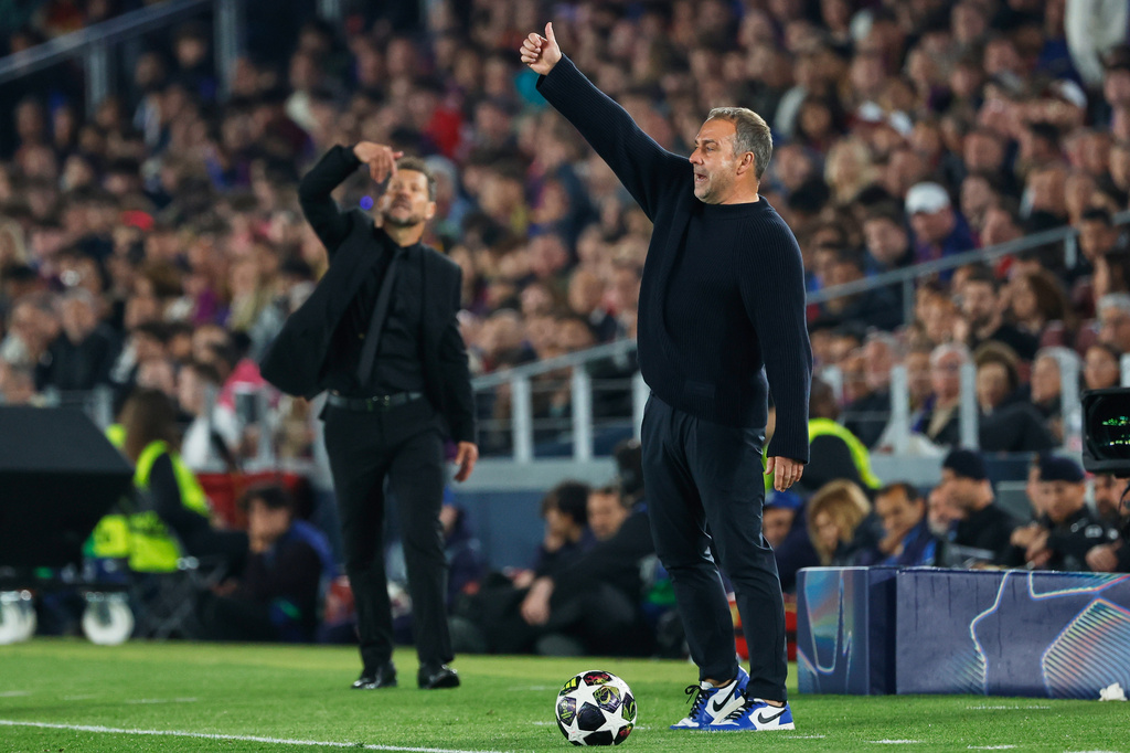 Barcelona's head coach Hansi Flick, right, and Atletico Madrid's head coach Diego Simeone react during the Champions League quarterfinal first leg soccer match between Barcelona and Atletico Madrid in Barcelona, Spain, Wednesday, April 8, 2026. (AP Photo/Joan Monfort)