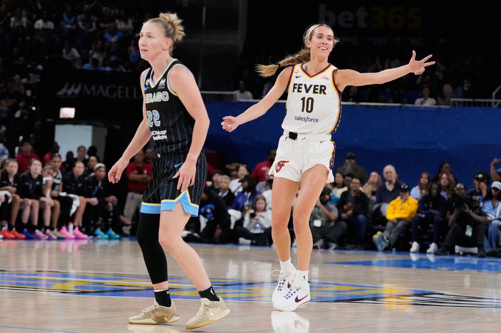 Indiana Fever guard Lexie Hull, right, reacts after scoring a 3-point basket as Chicago Sky guard Courtney Vandersloot, left, looks at a teammate during the first half of a WNBA basketball game Sunday, Aug. 23, 2026, in Chicago. (AP Photo/Nam Y. Huh)