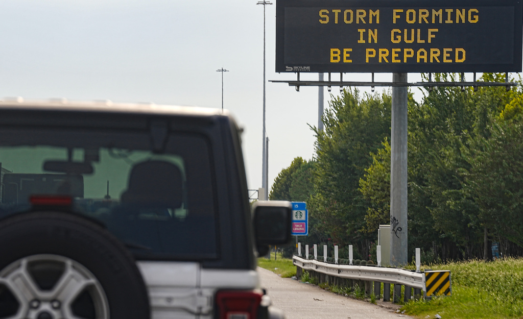 Motorists drive by Texas Department of Transportation signs on I-610 as Tropical Storm Edouard approaches in Houston, Tuesday, Sept. 1, 2026. (Elizabeth Conley/Houston Chronicle via AP)