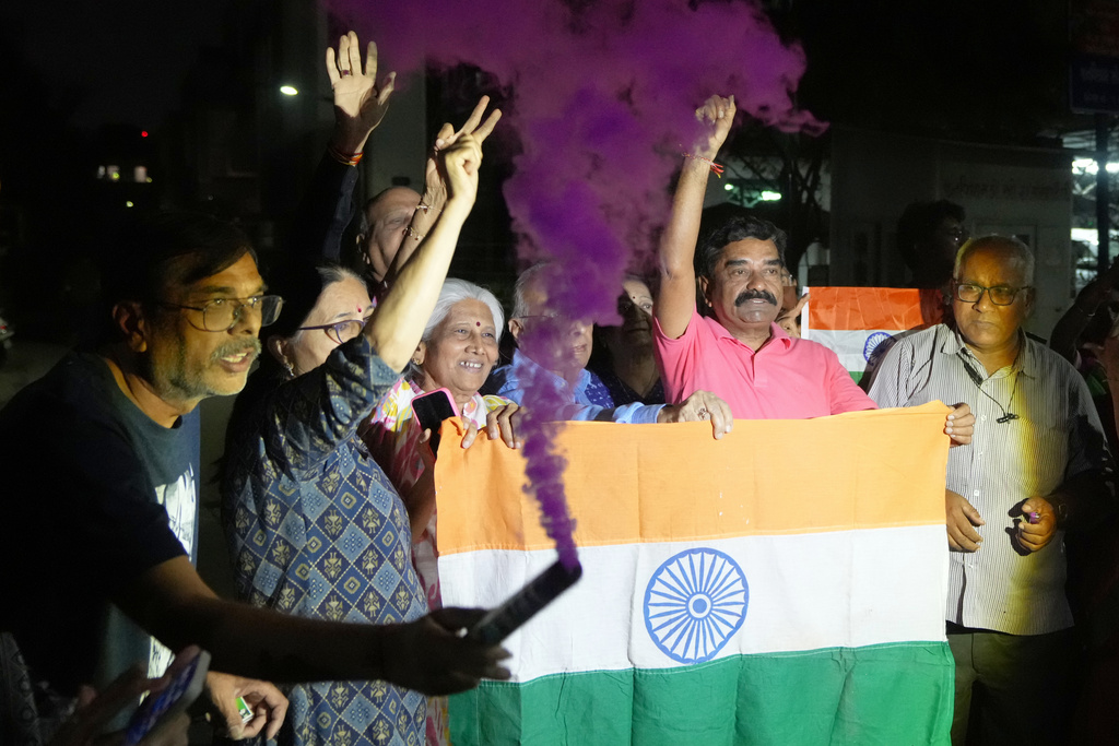 Indian fans celebrate Indian team's victory against Pakistan in ICC men's T20 World Cup cricket match played at Colombo in Sri Lanka, in Ahmedabad, India, Sunday, Feb. 15, 2026. (AP Photo/Ajit Solanki)