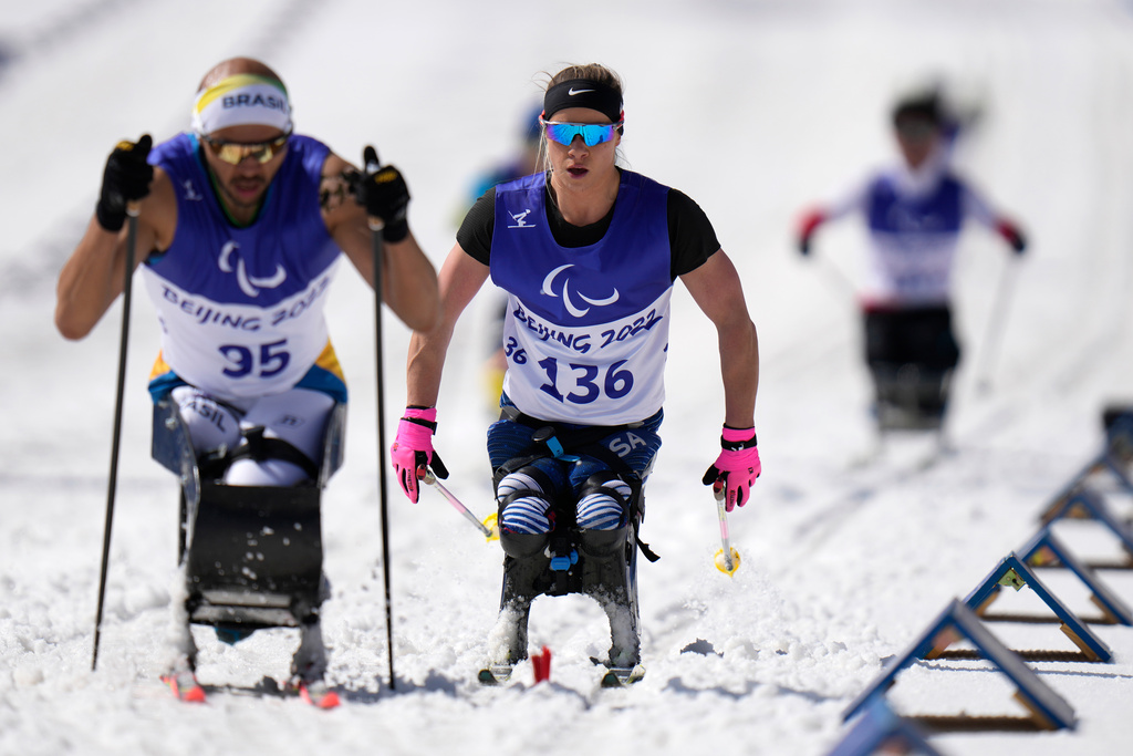 FILE - Oksana Masters, center, of the U.S. competes during a ceremony for the women's middle distance sitting event of para cross country skiing at the 2022 Winter Paralympics, Saturday, March 12, 2022, in Zhangjiakou, China. Masters took the silver medal. (AP Photo/Shuji Kajiyama, file)
