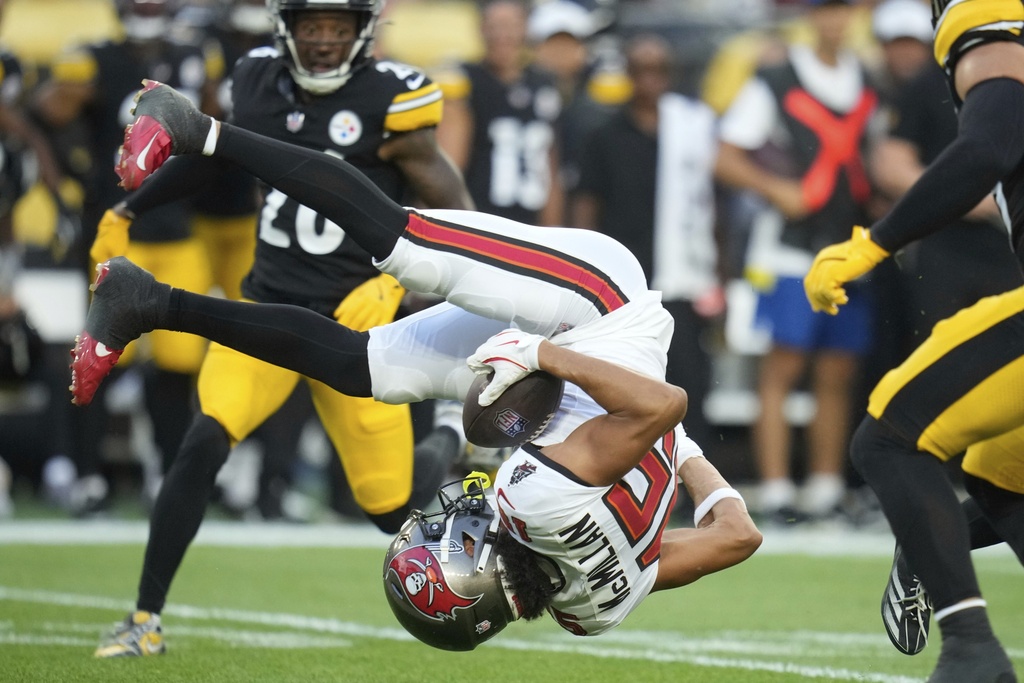 Tampa Bay Buccaneers wide receiver Jalen McMillan is upended by Pittsburgh Steelers cornerback Daryl Porter Jr. after catching a pass from quarterback Teddy Bridgewater during the first half of a preseason NFL football game, Saturday, Aug. 16, 2025, in Pittsburgh. (AP Photo/Sue Ogrocki)
