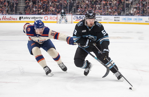Utah Mammoth's Michael Carcone (53) and Edmonton Oilers' Ty Emberson (49) battle for the puck during the first period of an NHL hockey game in Edmonton, Alberta, on Tuesday, Oct. 28, 2025. (Jason Franson/The Canadian Press via AP) Utah Mammoth's Michael Carcone (53) and Edmonton Oilers' Ty Emberson (49) battle for the puck during the first period of an NHL hockey game in Edmonton, Alberta, on Tuesday, Oct. 28, 2025. (Jason Franson/The Canadian Press via AP)