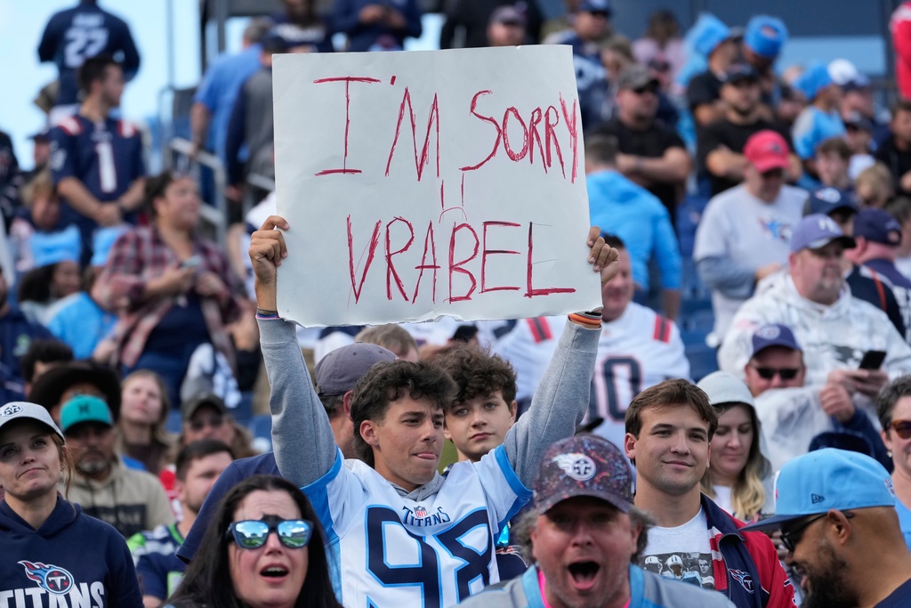 A Tennessee Titans fans holds up a sign during the second half of an NFL football game against the New England Patriots, Sunday, Oct. 19, 2025, in Nashville, Tenn. (AP Photo/George Walker IV)