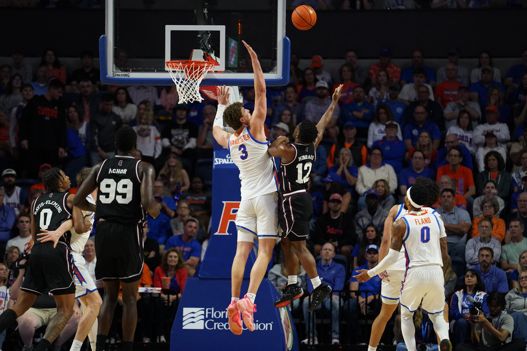 Mississippi State guard Josh Hubbard goes for a layup as Florida center Micah Handlogten attempts to block during the first half of an NCAA college basketball game, Tuesday, March 3, 2026, in Gainesville, Fla. (AP Photo/Morgan Hurd)