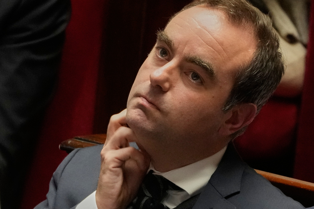 French Prime Minister Sebastien Lecornu looks on at France's National Assembly as parliament members vote on a national health care budget that would suspend Macron's unpopular pension reform raising the retirement age, in Paris, France, Tuesday, Dec. 9, 2025. (AP Photo/Michel Euler)