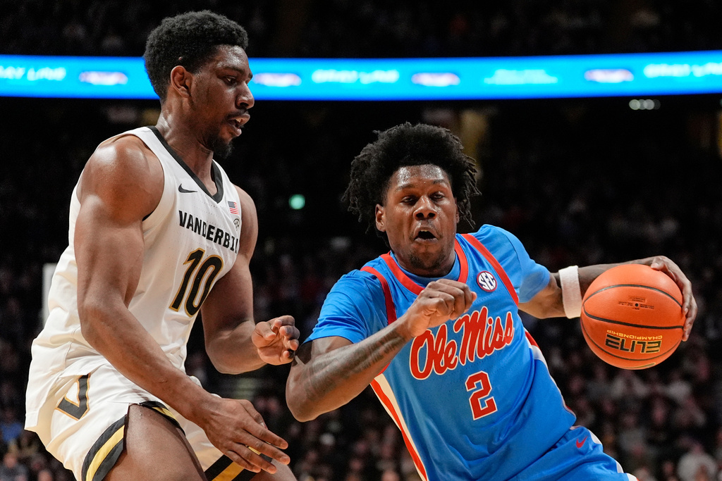 Mississippi guard AJ Storr (2) dribbles the ball past Vanderbilt forward AK Okereke (10) during the first half of an NCAA college basketball game Saturday, Jan. 31, 2026, in Nashville, Tenn. (AP Photo/George Walker IV)