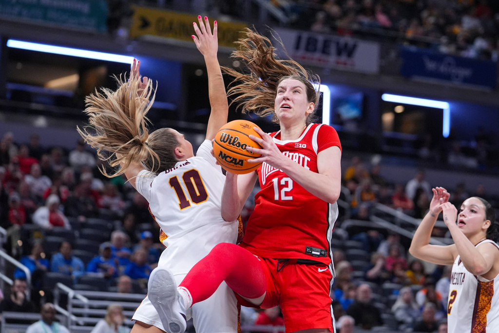 Ohio State center Elsa Lemmila (12) grabs a rebound over Minnesota guard Mara Braun (10) in the first half of an NCAA college basketball game in the quarterfinals of the Big Ten Conference tournament, Friday, March 6, 2026 in Indianapolis. (AP Photo/Michael Conroy)