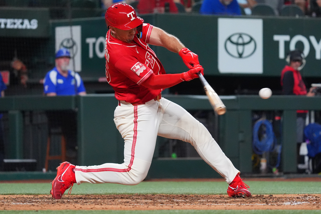 Texas Rangers' Wyatt Langford hits a double during the sixth inning of a baseball game against the Cleveland Guardians, Friday, June 5, 2026, in Arlington, Texas. (AP Photo/LM Otero)
