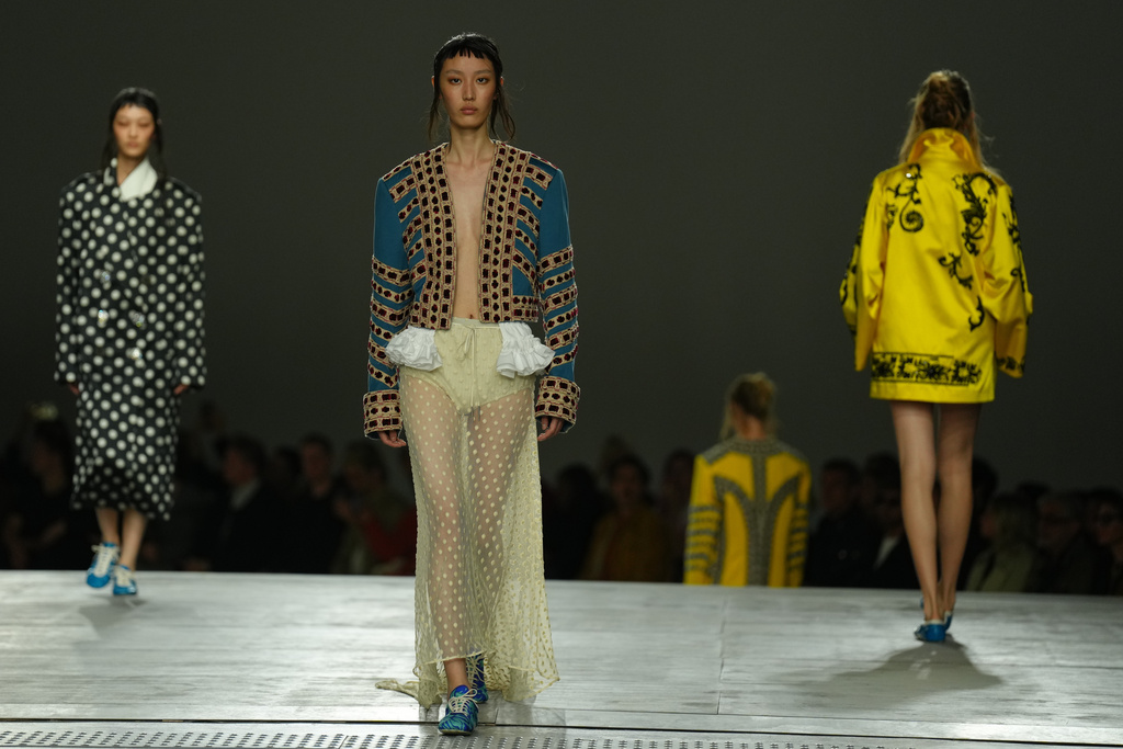 Models wear creations as part of the Dries Van Noten Spring/Summer 2026 collection presented in Paris, Tuesday, Sept. 30, 2025. (AP Photo/Aurelien Morissard)