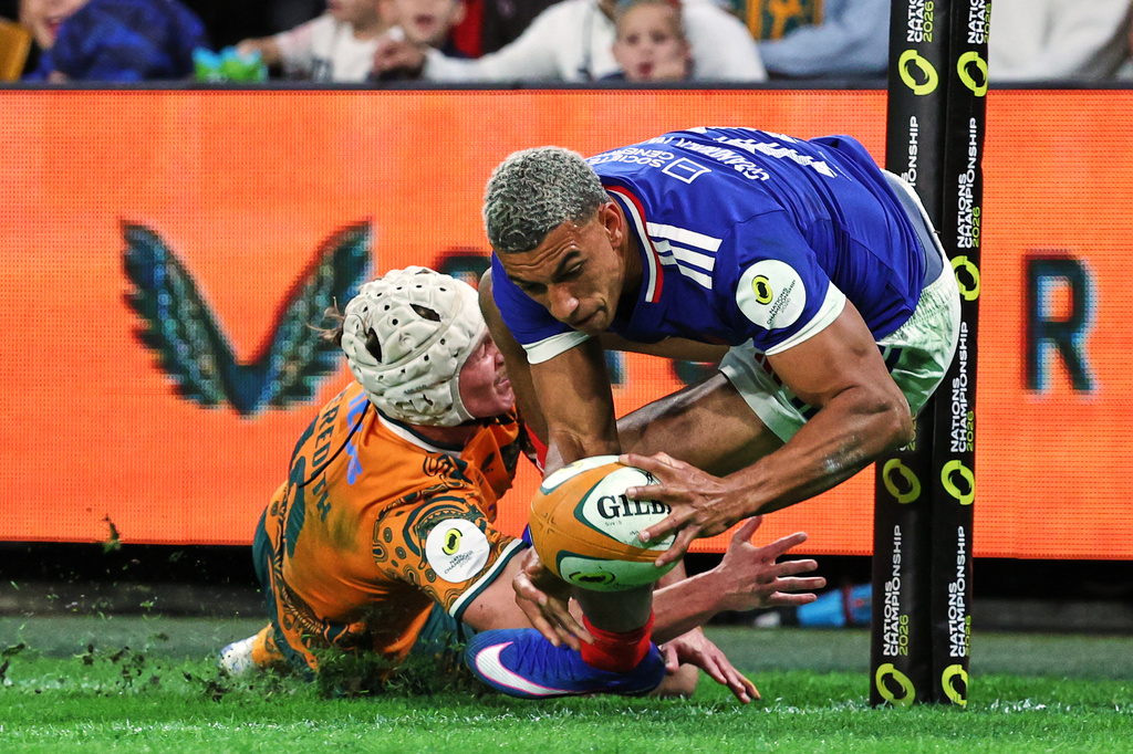 France's Aaron Grandidier-Nkanang scores a try in the tackle of Australia's Declan Meredith during the Nations Championship rugby international between France and Australia in Brisbane, Australia, Saturday, July 11, 2026. (AP Photo/Tertius Pickard)