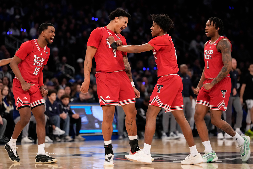 Texas Tech forward Lejuan Watts (3) celebrates with teammates after scoring during the first half of an NCAA college basketball game against Duke, Saturday, Dec. 20, 2025, in New York. (AP Photo/Yuki Iwamura)