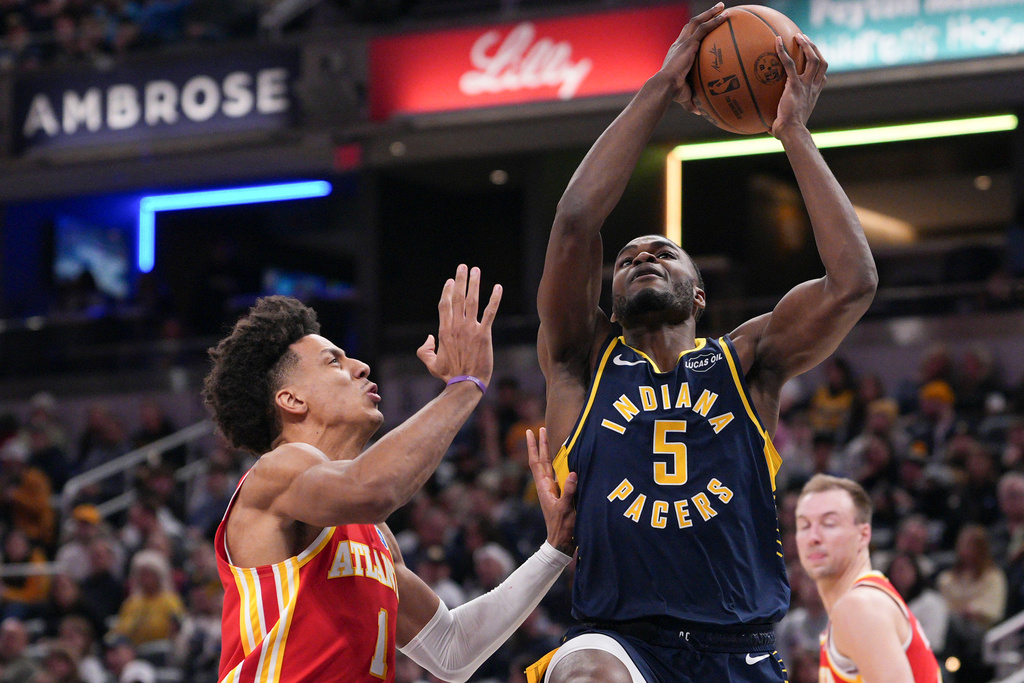 Indiana Pacers forward Jarace Walker (5) shoots in front of Atlanta Hawks forward Jalen Johnson (1) during the first half of an NBA basketball game in Indianapolis, Saturday, Jan. 31, 2026. (AP Photo/AJ Mast)