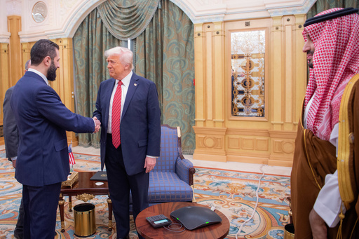 FILE - In this photo provided by the Saudi Royal Palace, Syria's interim President Ahmad al-Sharaa, left, shakes hands with U.S. President Donald Trump in Riyadh, Saudi Arabia, Wednesday, May 14, 2025. At foreground right is Saudi Crown Prince Mohammed bin Salman. (Bandar Aljaloud/Saudi Royal Palace via AP, File) FILE - In this photo provided by the Saudi Royal Palace, Syria's interim President Ahmad al-Sharaa, left, shakes hands with U.S. President Donald Trump in Riyadh, Saudi Arabia, Wednesday, May 14, 2025. At foreground right is Saudi Crown Prince Mohammed bin Salman. (Bandar Aljaloud/Saudi Royal Palace via AP, File)